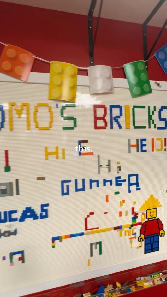 A colourful LEGO message wall inside Romo's Bricks